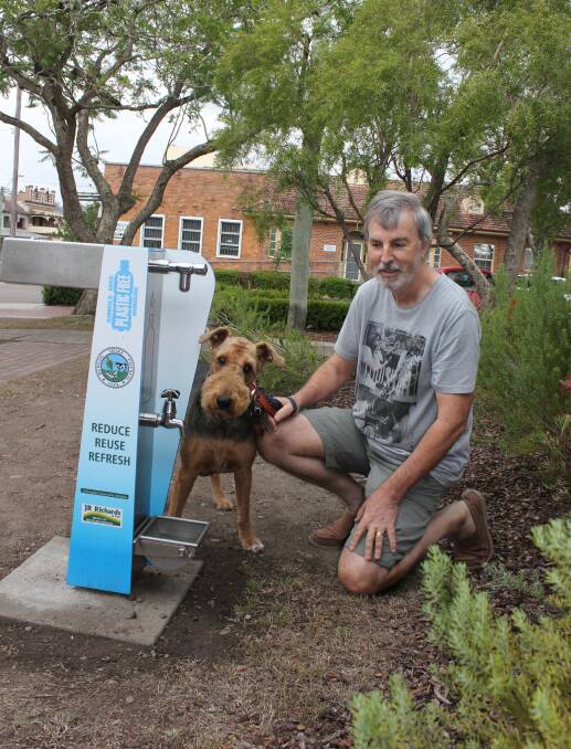 Thirsty work: Chris Priday stops on his walk as his pooch Roxy tries out the new fountain in Dowling Street. The water station has a built in animal water dish, is disability accessible and carries the Single Use Plastic Free Dungog message. Photo: Michelle Mexon