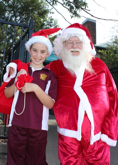 YOU'RE INVITED: Santa's little helper Aimee Debbage, 10, with Trevor Andrews, also known as Santa, are already getting into the Christmas spirit for the luncheon.