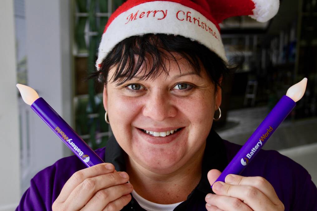 CHRISTMAS GLOW: Katie Hallinan from Maitland Battery World who has donated 1000 battery operated candles to the Paterson Rotary carols night on December 22.