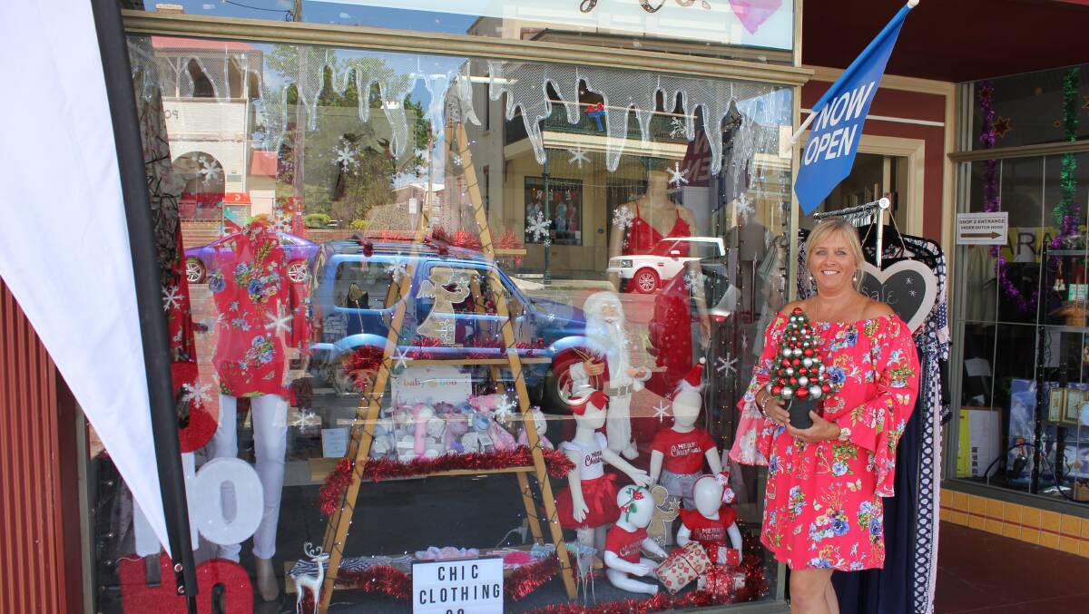 Kim Daughtrey in front of the Chic Clothing Co window in  Dowling Street, Dungog, which is one of the many entrants in the shire-wide competition.