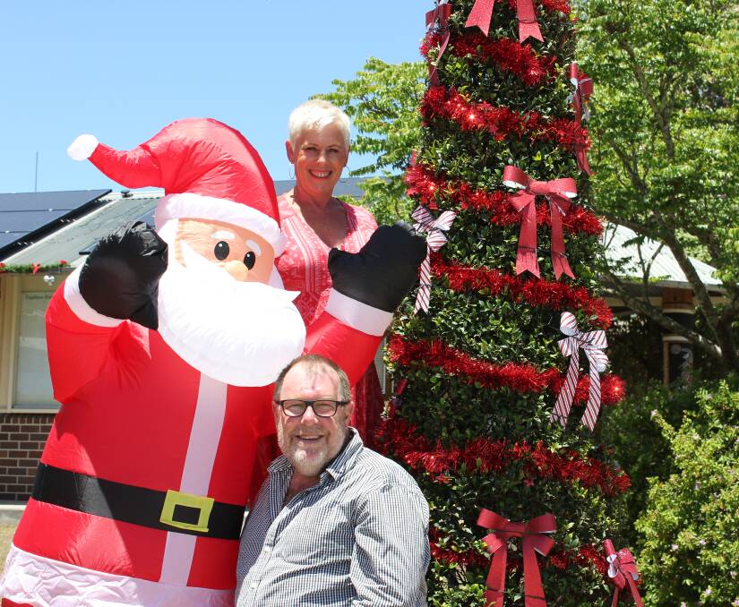 FESTIVE: Dungog and District Chamber of Commerce President Jennifer Lewis with Dungog Shire Council's Economic Development, Tourism and Events Manager Ivan Skaines and the new Christmas tree.