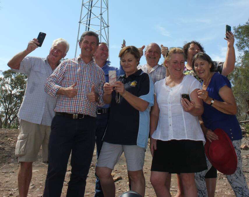 CALLS ANSWERED: Robert Betts, David Gillespie MP, James Gardner, Cath Varcoe, Kevin Hawtin, Cr Sally Halliday, Telstra's Area General Manager Tricia Wilson and Janet Steele celebrate the tower's switch-on.