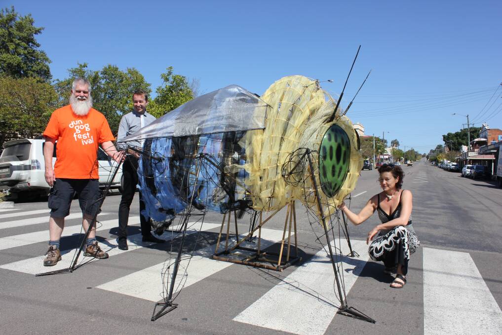 ARTY: Matthew Coxhill and Michael Atkins help artist Kassandra Bossell and her work "Could Bee" to cross Dowling Street in preparation for the festival. Photo: Michelle Mexon