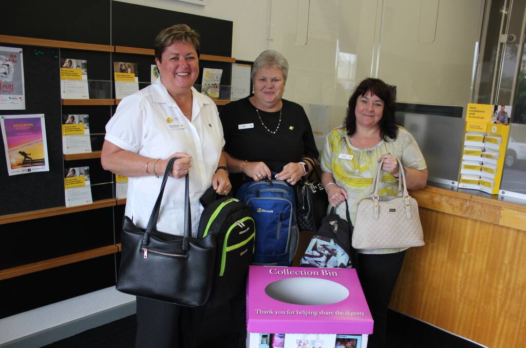 DONATIONS NOW OPEN: Dungog CBA manager Karen Hancock with staff Sam Rumbel and Donna Skinner are hoping people will drop a bag in before December 2.