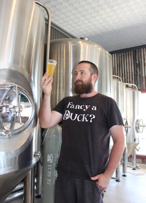 SCIENCE OF BEER: Jimmy Cox, of the Tinshed Brewery, checks on one of his latest creations. Picture: Michelle Mexon