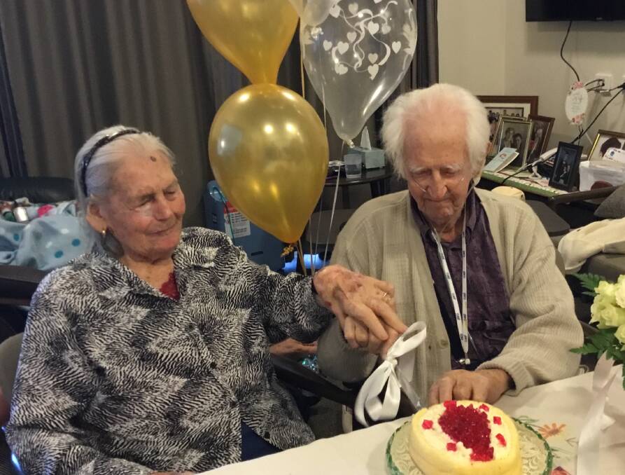 CELEBRATION: Dorothy and John cut their cake.