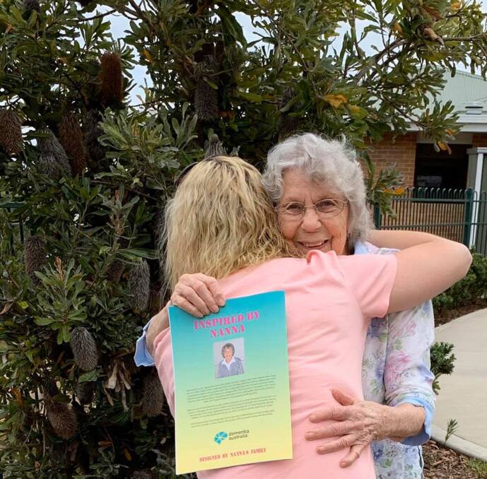 Delight: Heather Baker hugs her granddaughter Gina, who, with her family, created a colouring book for people with dementia.