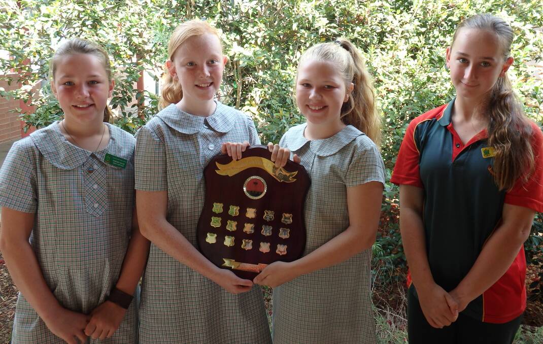 WINNING SMILES: The Clarence Town debating team with the shield.