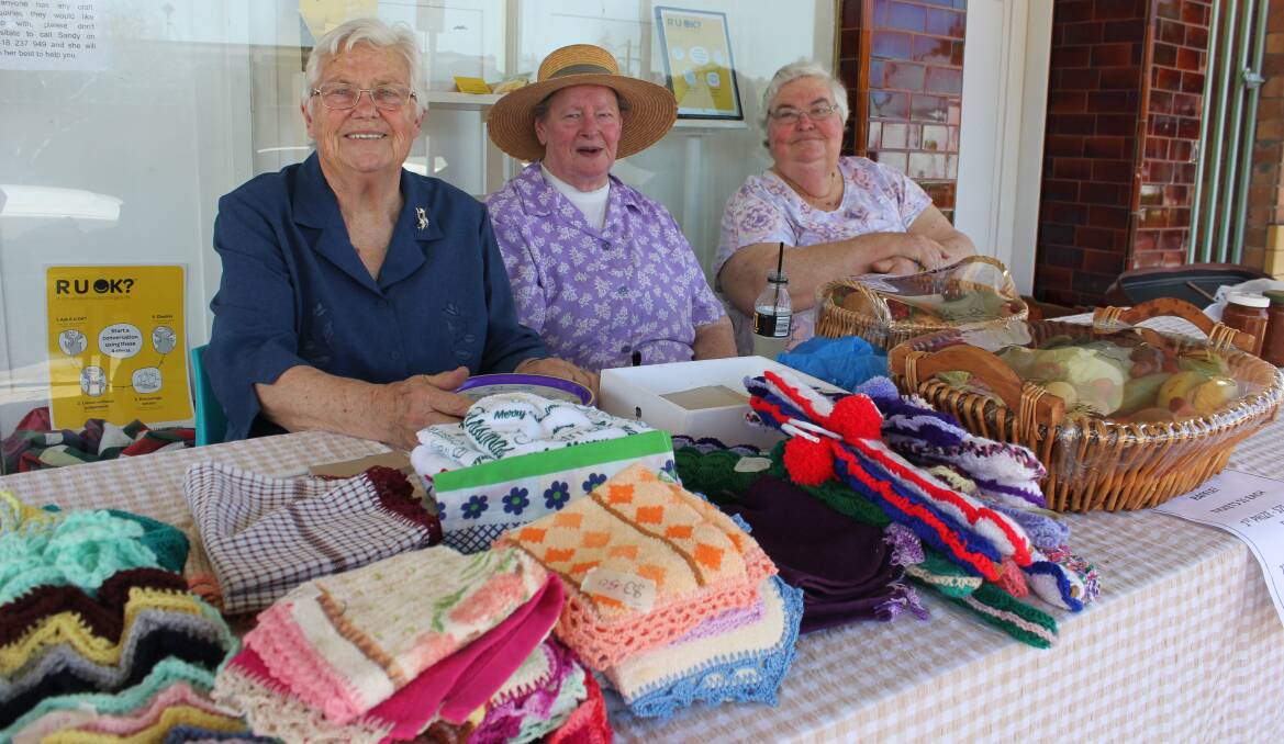 SPREADING SUNSHINE: Shirley Rumbel, Eileen Nicholson and Kay Edwards in Dowling Street last week for the street stall which was brimming with handmade goods.