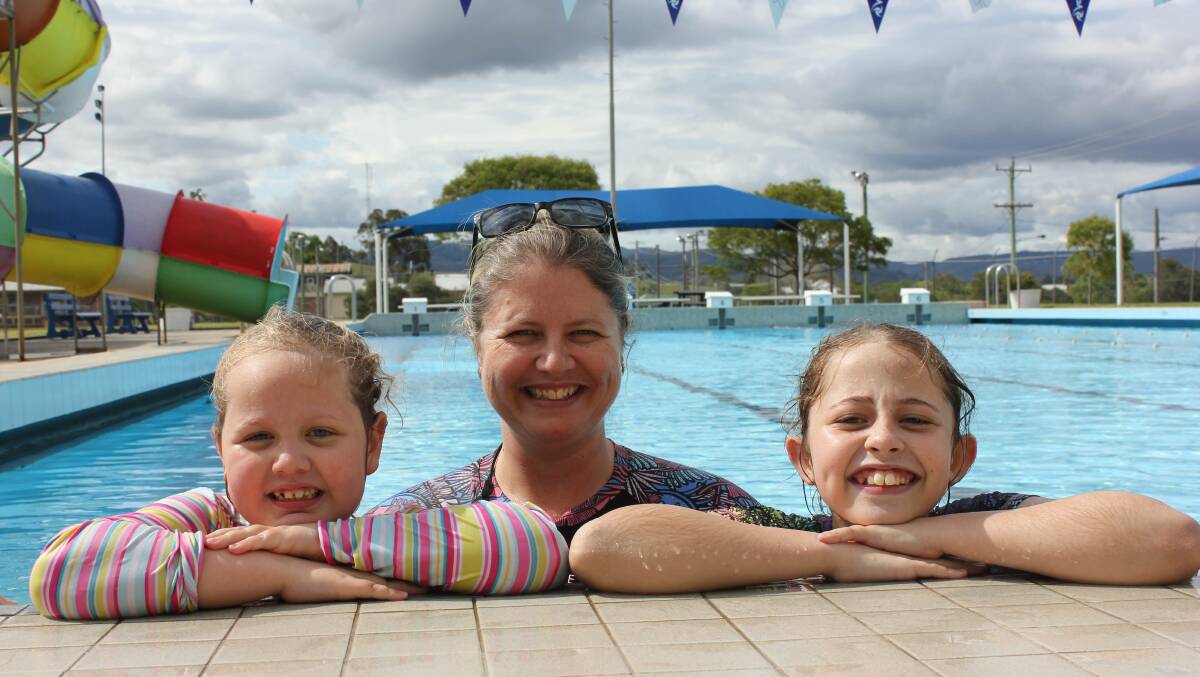 FUN: All smiles enjoying their first swim of the season at Dungog pool when it opened in October were Bonny Hynes with her mother Casey and sister Shayne.