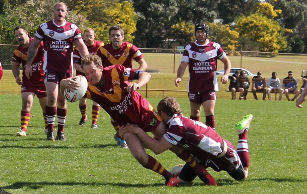 Dungog's Phil Badior dives across the line to score a try. Picture: Jeanie Briggs