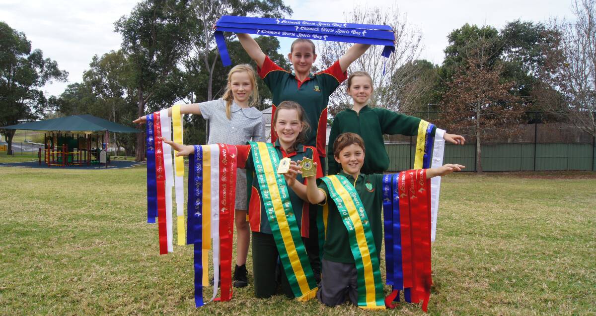 WINNERS: Emily and Harrison (front) with Deynah (left), Emma (centre) and Mia (right), and the ribbons they won at the Cessnock Horse Sports Day. Picture: BELINDA-JANE DAVIS