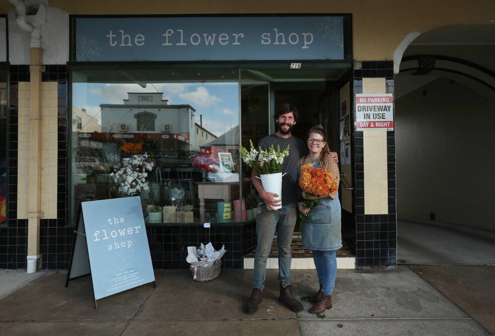 FLOWER POWER: Tom Christie and Dominique Northam outside The Flower Shop in Dungog, which they bought in 2019. Picture: Simone De Peak