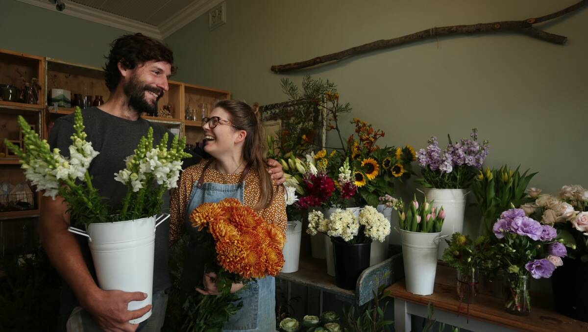 BEAUTIFUL BLOOMS: Tom Christie and Dominique Northam outside The Flower Shop in Dungog, which they bought in 2019. Picture: Simone De Peak