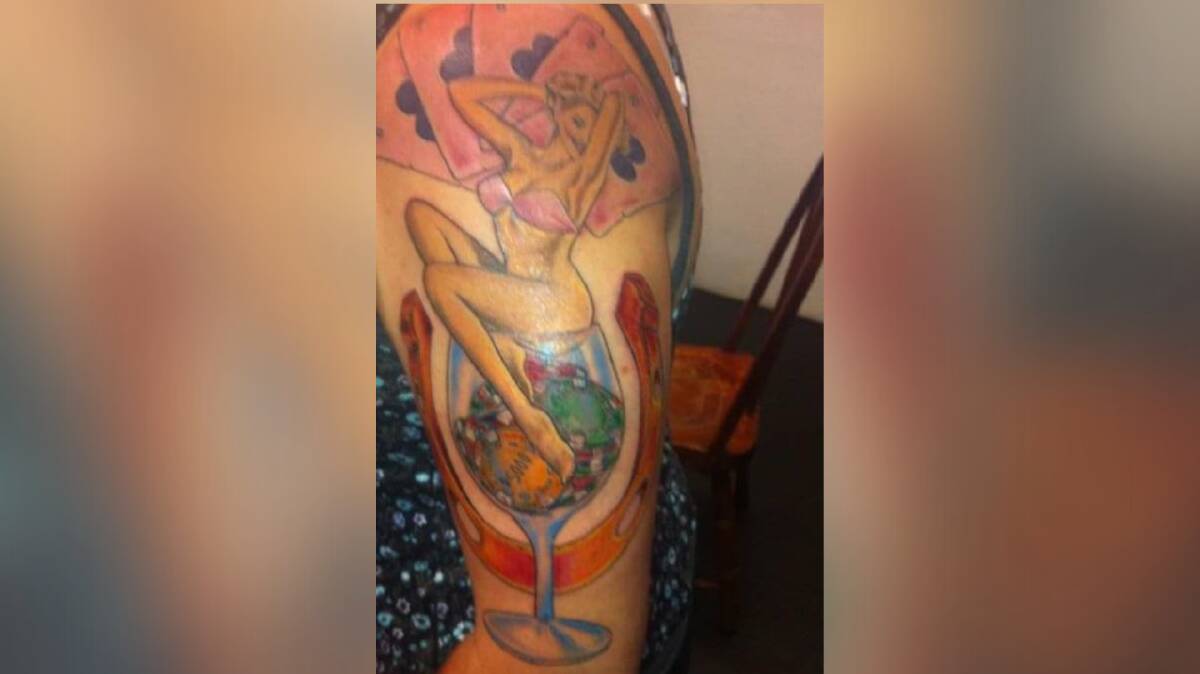 EBB JACKSON: Shares her story behind this tattoo of a lady sitting atop a wine glass filled with poker chips, holding the hand of cards she won with in Las Vegas. Photo: Supplied.