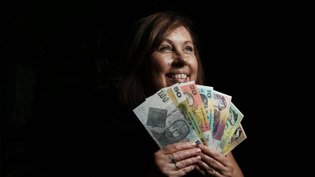 CASHED UP: Sue Jarrett from Campbell's Store, Morpeth with some of the old bank notes that will be on display this weekend. PICTURE: Simone De Peak.