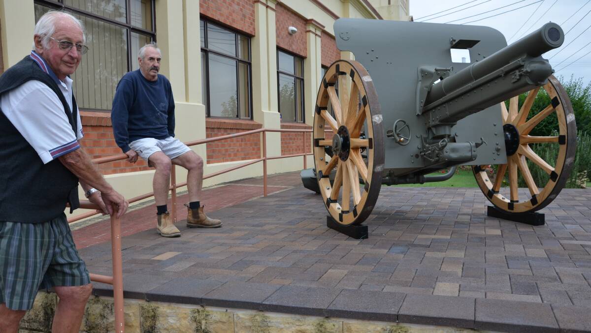 NEW WHEELS: The WW1 Krupp field gun now has new wheels.  Pictured are Jim Olsen and Geoff Bunt who assisted with its restoration.