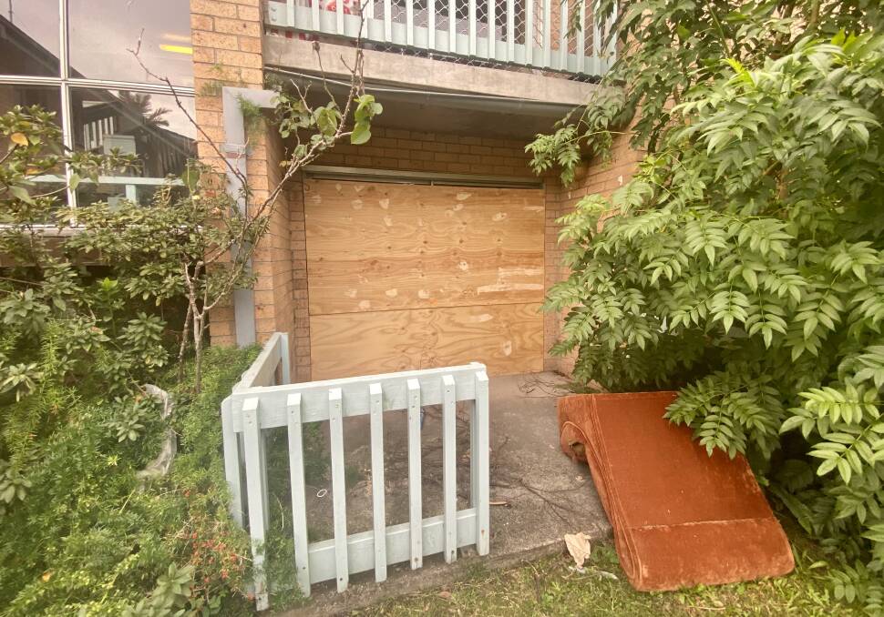 The front sliding door boarded up after Christine's death.