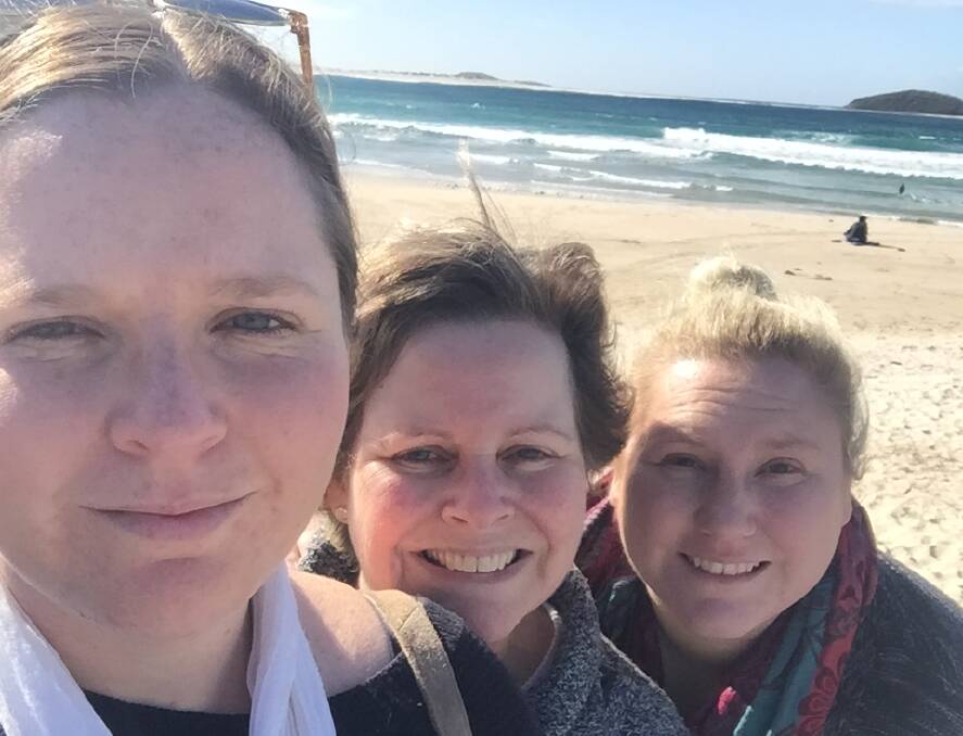 Memories: Sharon Jenkins with daughters Cidney and Kim at Fingal Bay on Monday on what should have been Tony Jenkins' 55th birthday. 