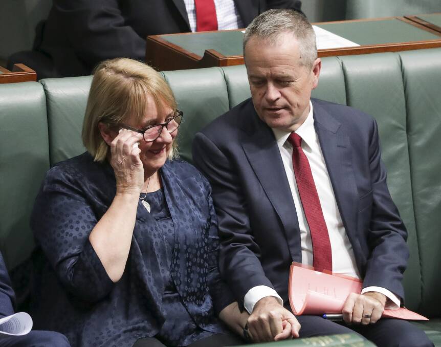 Comfort: Labor leader Bill Shorten supports an emotional shadow social services minister Jenny Macklin after her speech in Federal Parliament in May supporting a national redress scheme for child sexual abuse survivors.