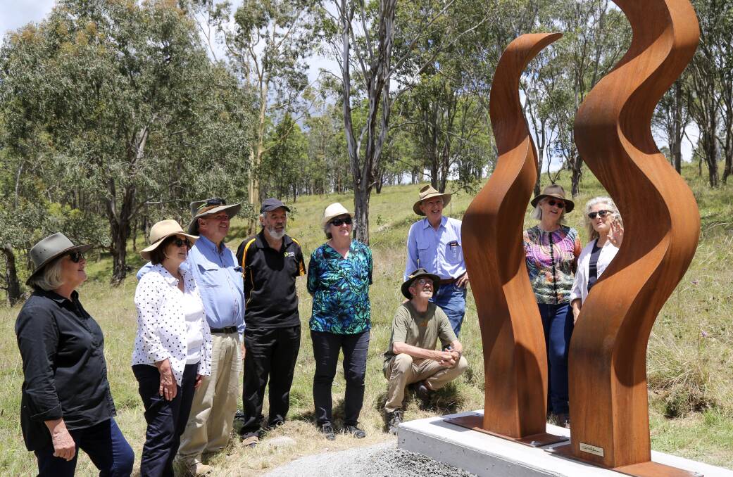 The Sculpture on the Farm and Dungog Common committees with artist Jen Mallinson (far right) and her sculpture, Sowelu Two.