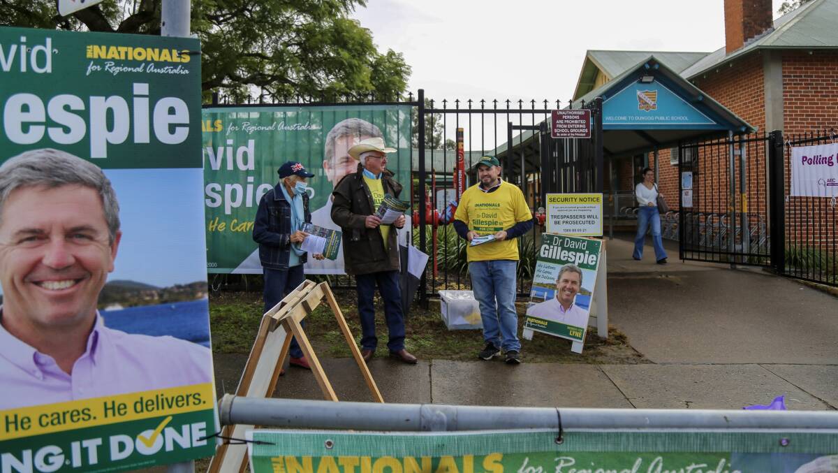 ELECTION DAY: Volunteers handing out how to vote cards for The Nationals at Dungog Public School on Saturday morning. Picture: Ellie-Marie Watts