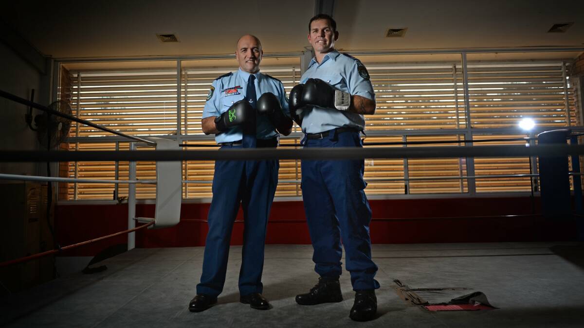 Wayne Humphrey, then a Detective Chief Inspector, with Senior Constable Brendon Haile preparing for a fight night in 2014 to raise money for Police Legacy.