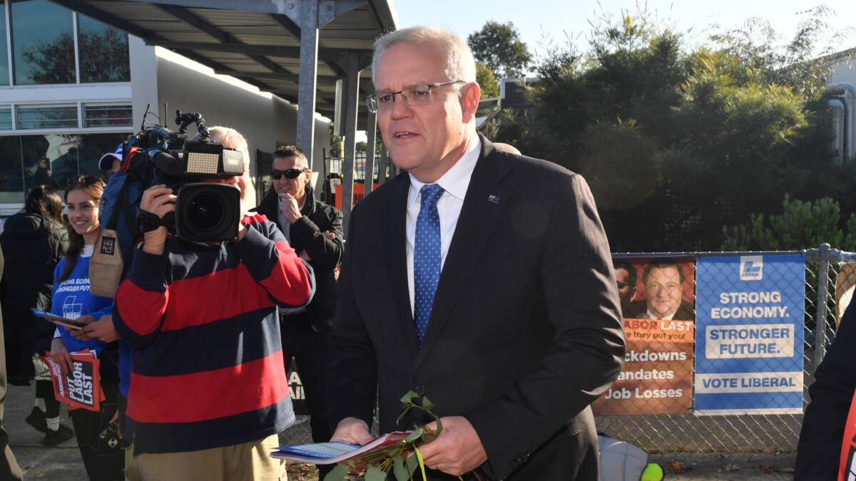 Scott Morrison was handing out how-to-vote cards on election day on Melbourne. Picture: AAP