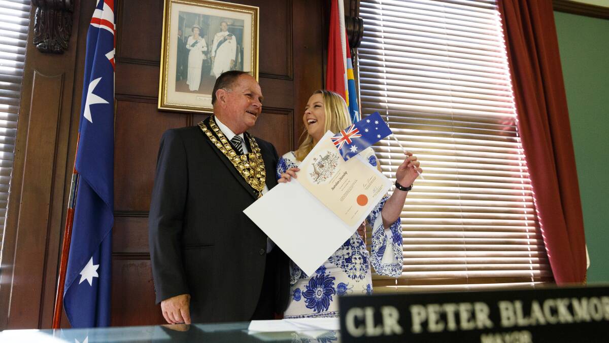 Peter Blackmore posing for a photo with new Australian citizen Amy Suessmeier, formerly of Canada, at his final citizenship ceremony as Maitland Mayor. Picture: Max Mason-Hubers 