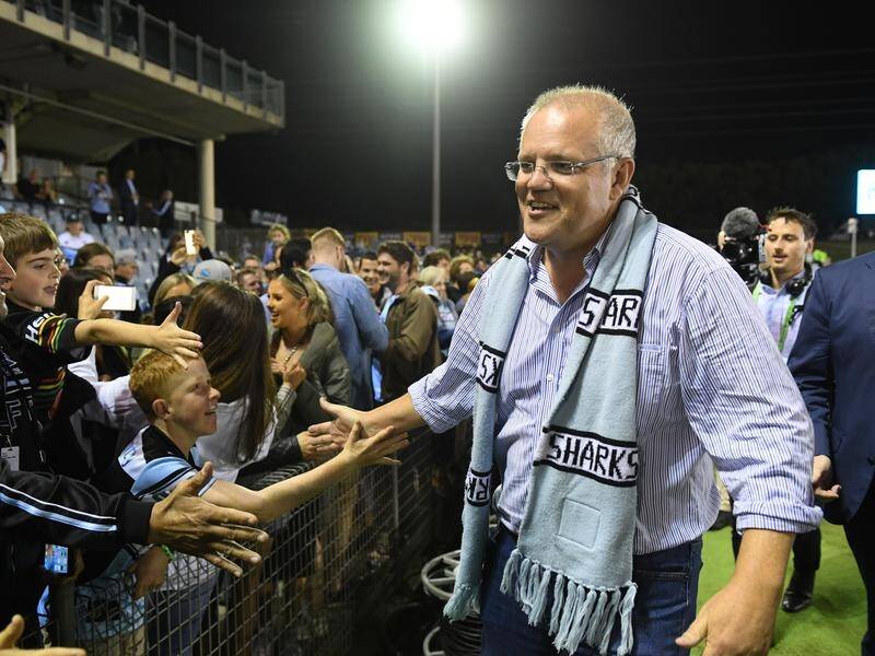 PM Scott Morrison(R) jetted back to Sydney last night to see the Sharks overcome a 14-point deficit.