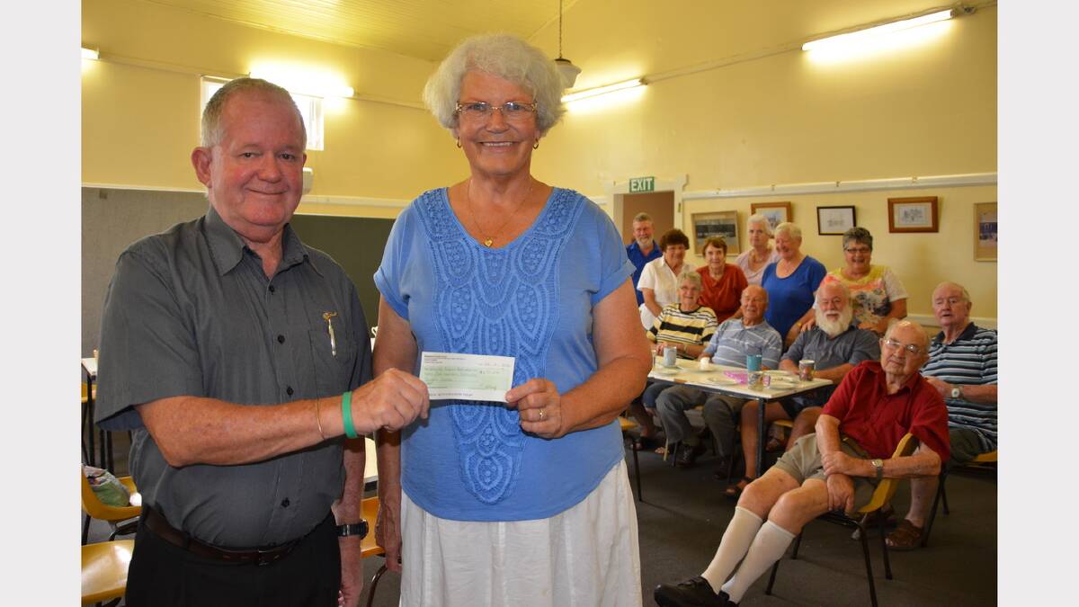 Barry Walton from the Westpac Rescue Helicopter Service accepting the cheque from Cuppa and Chat organiser Pauline Aboody