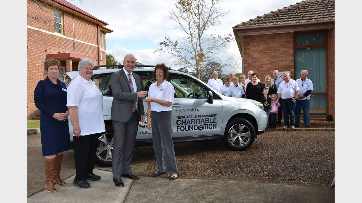 Dungog Shire Palliative Care Volunteers coordinator Jennie Wilson, president Margaret Jones and transport coordinator Lyn Moseley accepting the keys to the new car from Newcastle Permanent Charitable Foundation executive officer Jason Bourke on Monday.