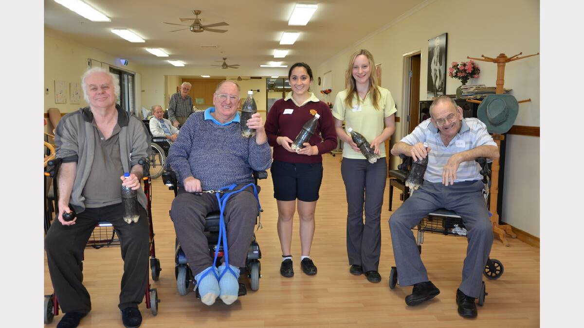 Students Molly Wallace and Racheal Pace playing 10 pin bowls with residents John Gutewicz, Dennis Parish and Colin Smith