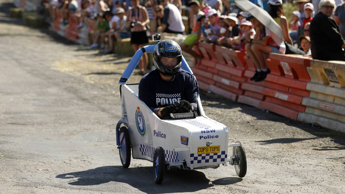 RACING: A competitor roars down the road at this year's Gresford Billy Cart Derby.