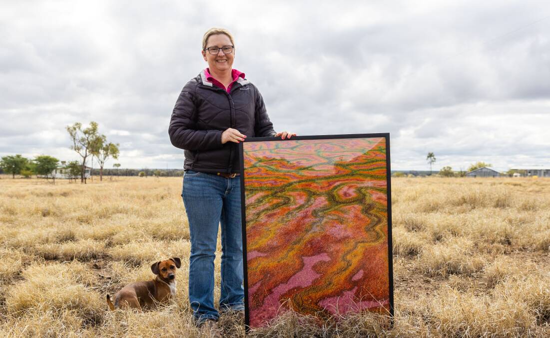 Lisa Alexander, Blackall, with her international award winning Channel Country picture. Picture supplied.